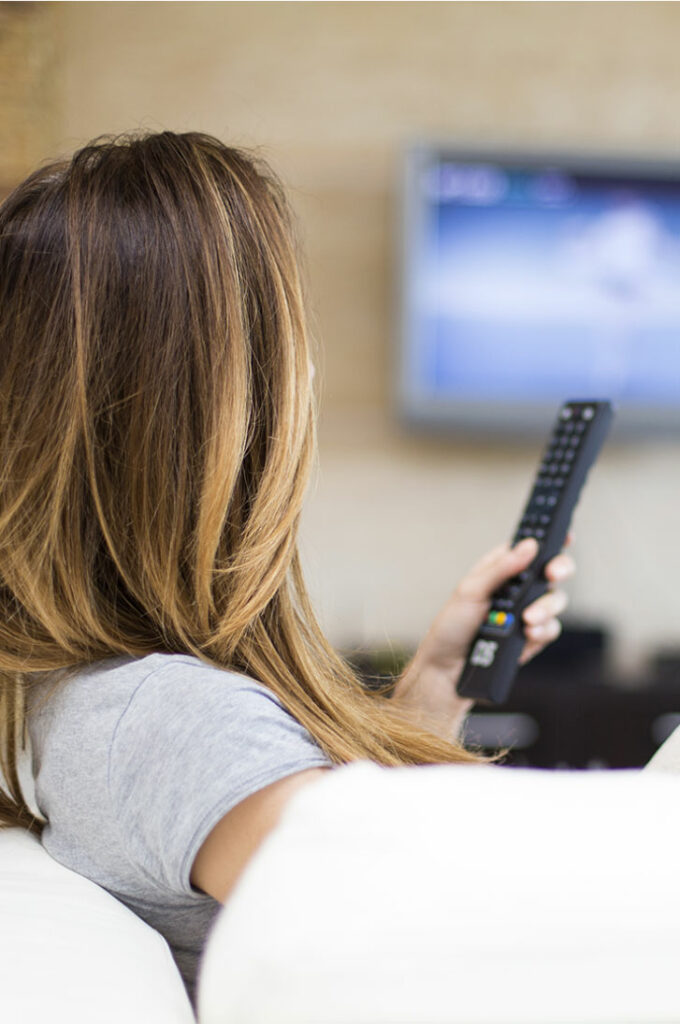 hotel guest watching tv in their room