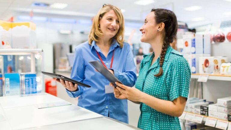 young woman with tablet pc shopping in-store